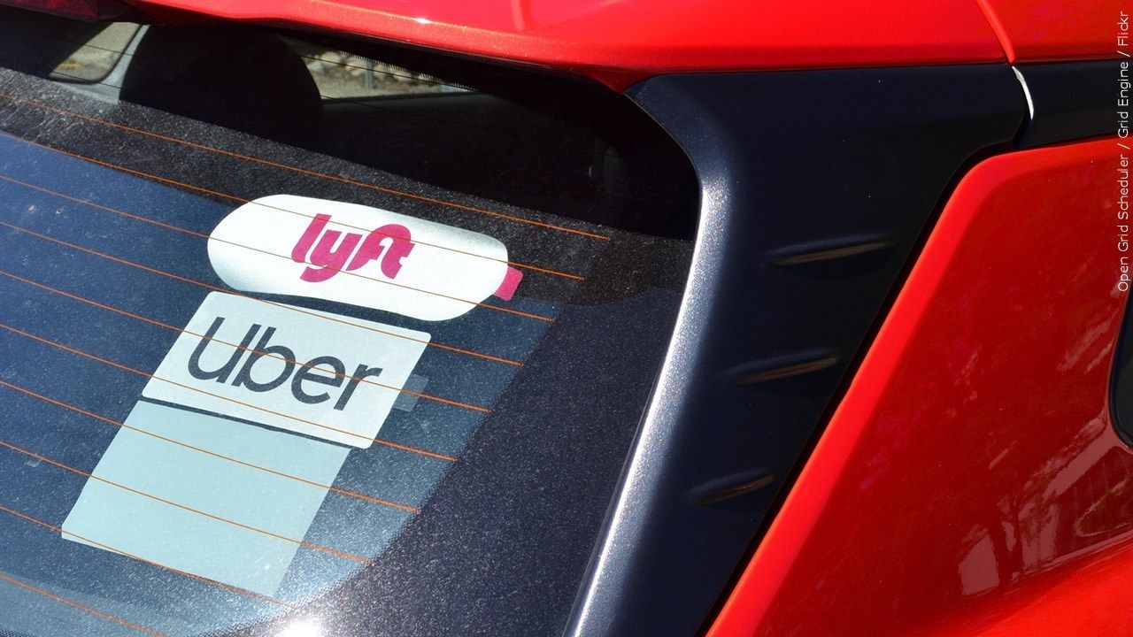 Lyft and Uber stickers on a car