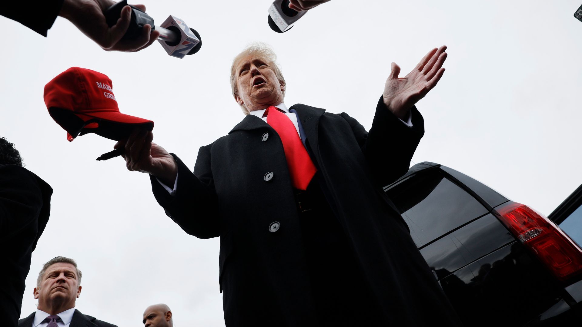 Donald Trump talks to reporters while visiting the polling site January 23, 2024 in Londonderry, New Hampshire.