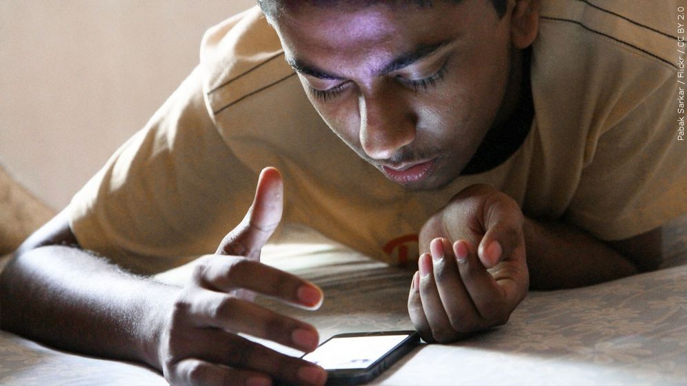 Teen reading on smartphone